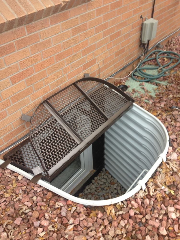 Window well grate installed on brick window well